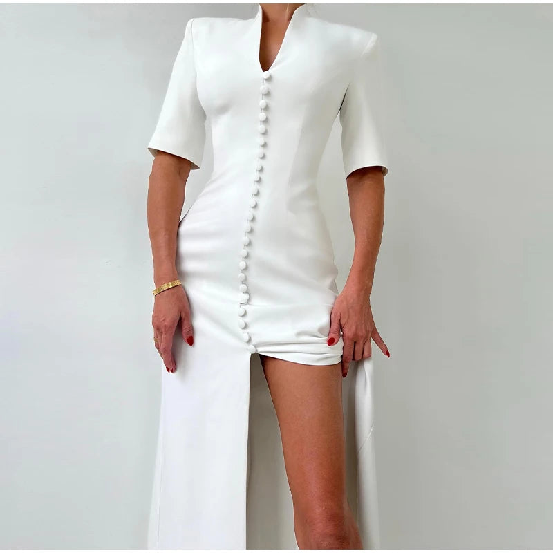 White dress with button details on a plain background