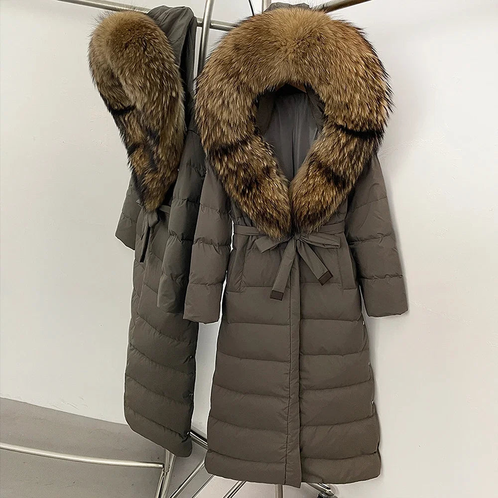 Two brown puffer coats with fur collars on a white background