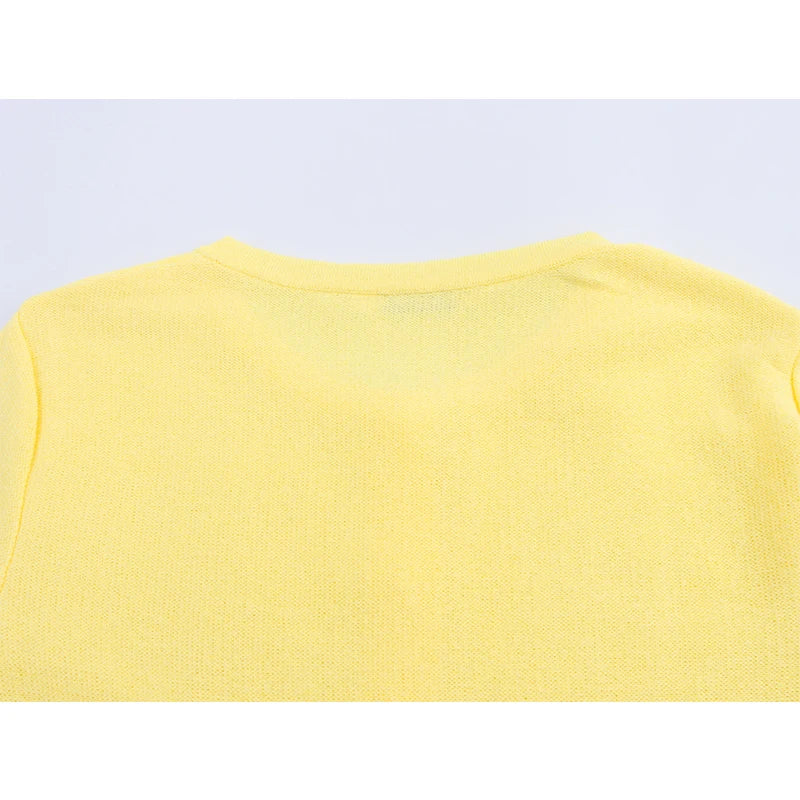 Yellow sleeveless top on a light purple background