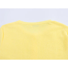 Yellow sleeveless top on a light purple background