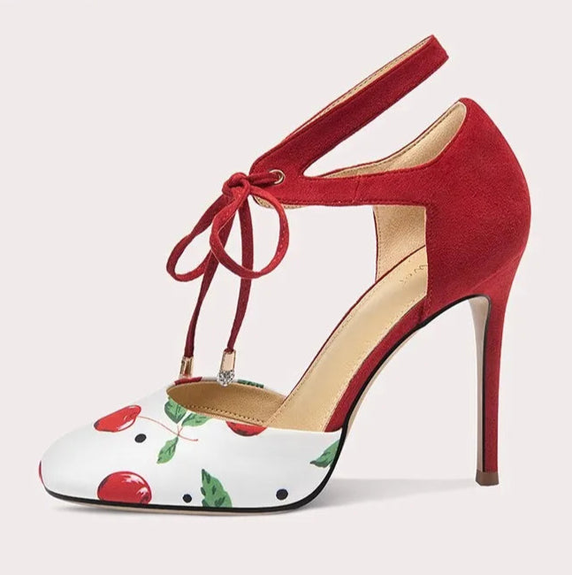 Red high-heeled shoe with floral pattern on a white background
