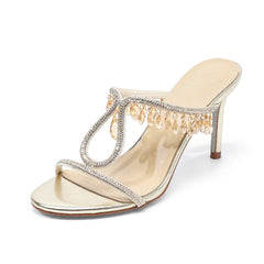 Gold high-heeled sandal with crystal embellishments on a white background