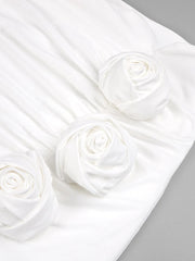 White satin fabric with rose patterns on a gray background