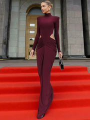 Woman in a burgundy evening gown on a red carpet