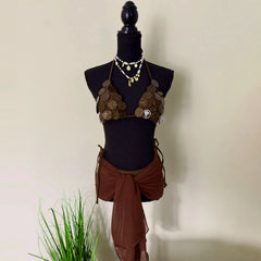 Brown bikini top with coin-like embellishments and a sheer brown wrap skirt.