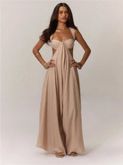Woman wearing a beige jumpsuit on a plain background