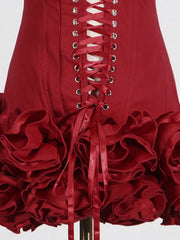 Red dress with ruffled skirt and corset-style lacing on a white background