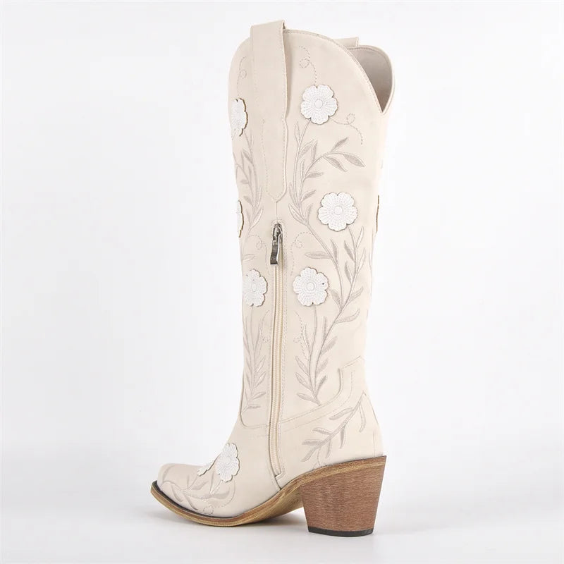 White cowboy boot with floral embroidery on a white background