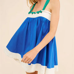 Blue and white dress with green accents on a beige background