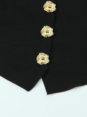 Close-up of a black garment with gold buttons on a white background
