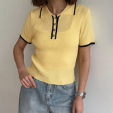 Ribbed knit polo collar cropped top with yellow color and black trim
