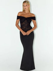 Woman wearing a black off-shoulder dress with lace detailing on a white background