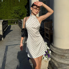 White polka dot halter neck mini dress in sunlight