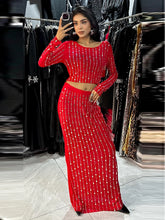 Woman in a red beaded outfit taking a mirror selfie in a store.
