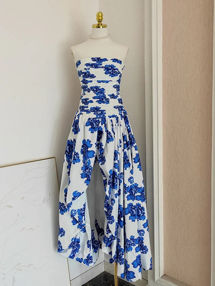 Blue floral strapless jumpsuit on a mannequin against a neutral wall.
