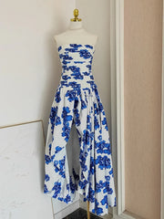 Blue floral strapless jumpsuit on a mannequin against a neutral wall.