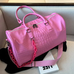 Pink crocodile embossed travel duffle bag with chunky chain detail