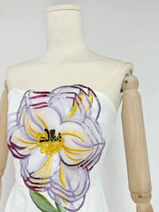 White dress with a large floral design on a mannequin against a white background