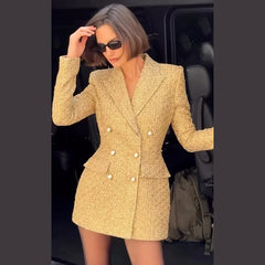 Woman wearing a gold blazer dress in a car.