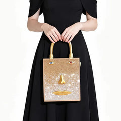 Sculptural face embellished bag with gold-tone nose and lips, and jewel-toned eye accents.