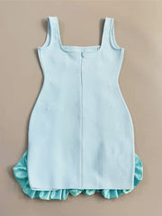 Light blue dress with ruffled hem on a beige background