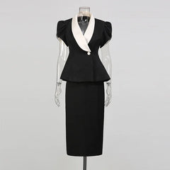 Black peplum blazer with white contrast lapels and a black midi skirt displayed on a mannequin.