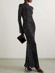 Crystal embellished turtleneck midi dress styled with a clutch.