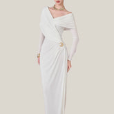 White evening gown with gold accents on a plain background