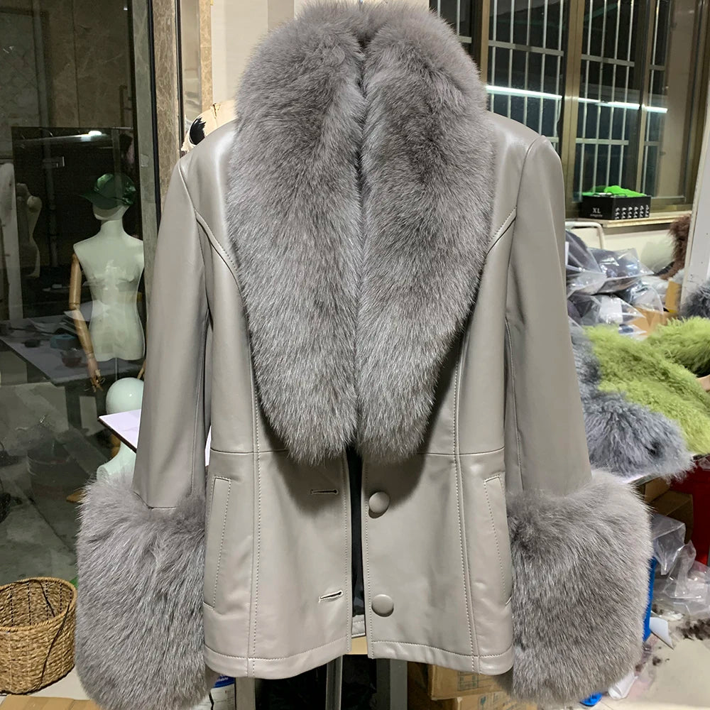 Light-colored leather jacket with gray fur trim on a mannequin in an indoor setting.