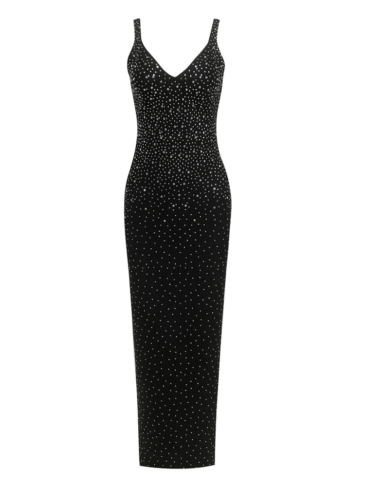 Black dress with white polka dot pattern on a white background