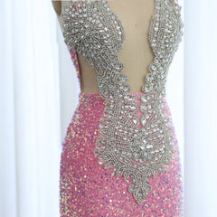 Pink dress with silver beading on a mannequin against a white background