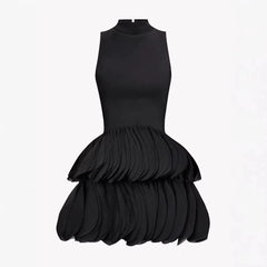 Product shot of a black sleeveless turtleneck dress with a ruffled mini skirt, displayed on a white background.