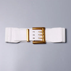 White belt with a gold buckle on a gray background