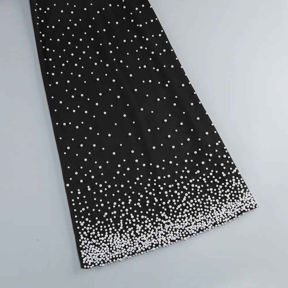 Black fabric with white polka dots on a light gray background