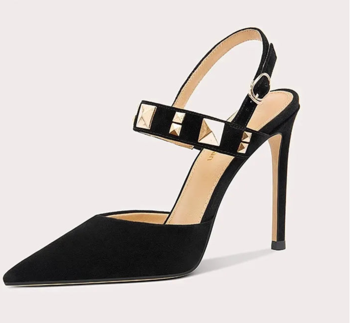 Black high-heeled shoe with studded details on a light gray background