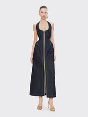 Woman wearing a black sleeveless dress with a zipper on a white background