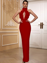 Woman wearing a red evening gown in an elegant interior setting