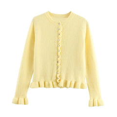 Yellow cardigan with buttons on a white background