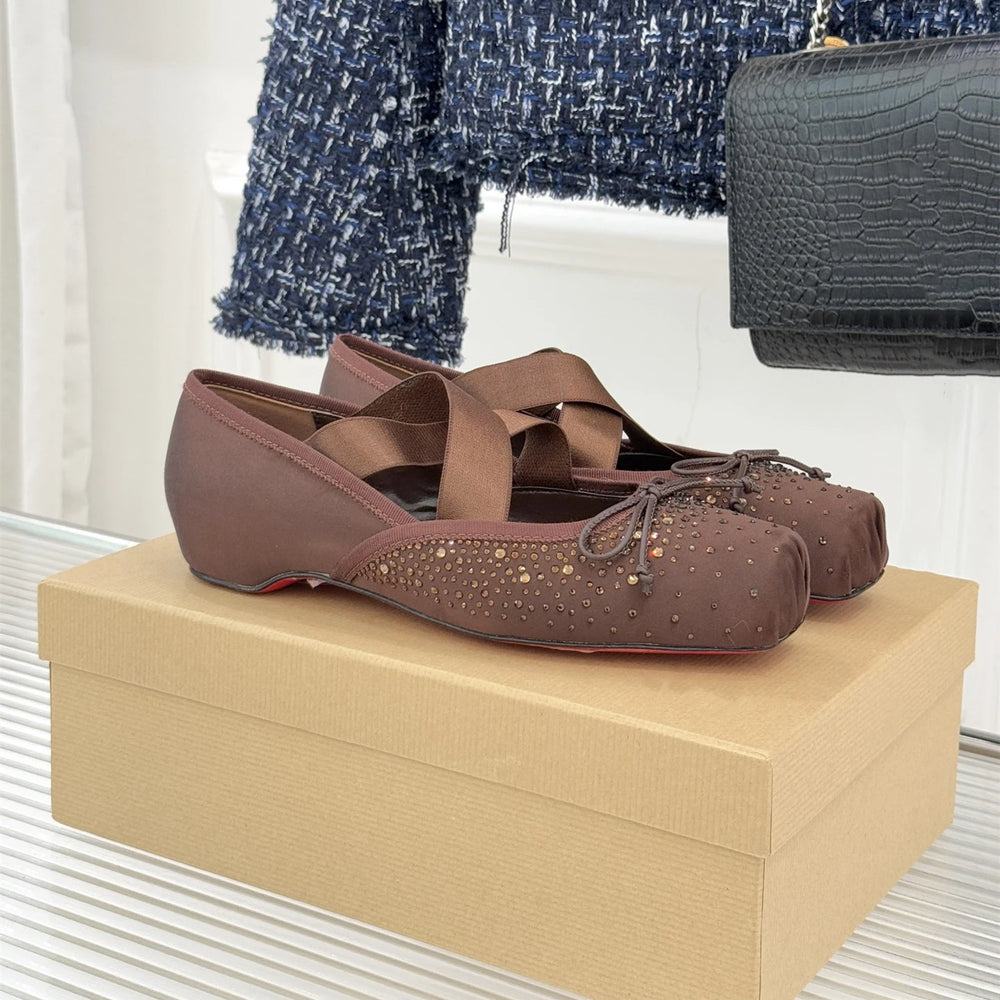 Brown shoes on a beige box with a blurred background