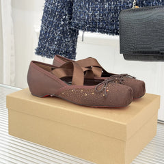 Brown shoes on a beige box with a blurred background