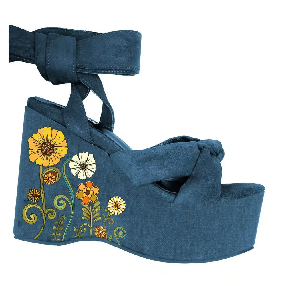 Blue wedge sandal with floral design on a white background