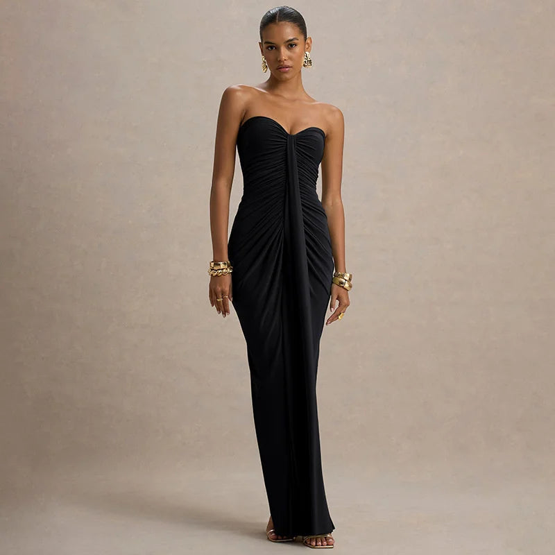 Woman wearing a black strapless gown against a beige background