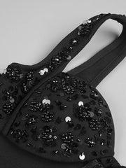 Black embellished bag on a light gray background