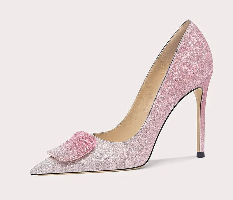 Pink glitter high-heeled shoe with a decorative bow on a white background