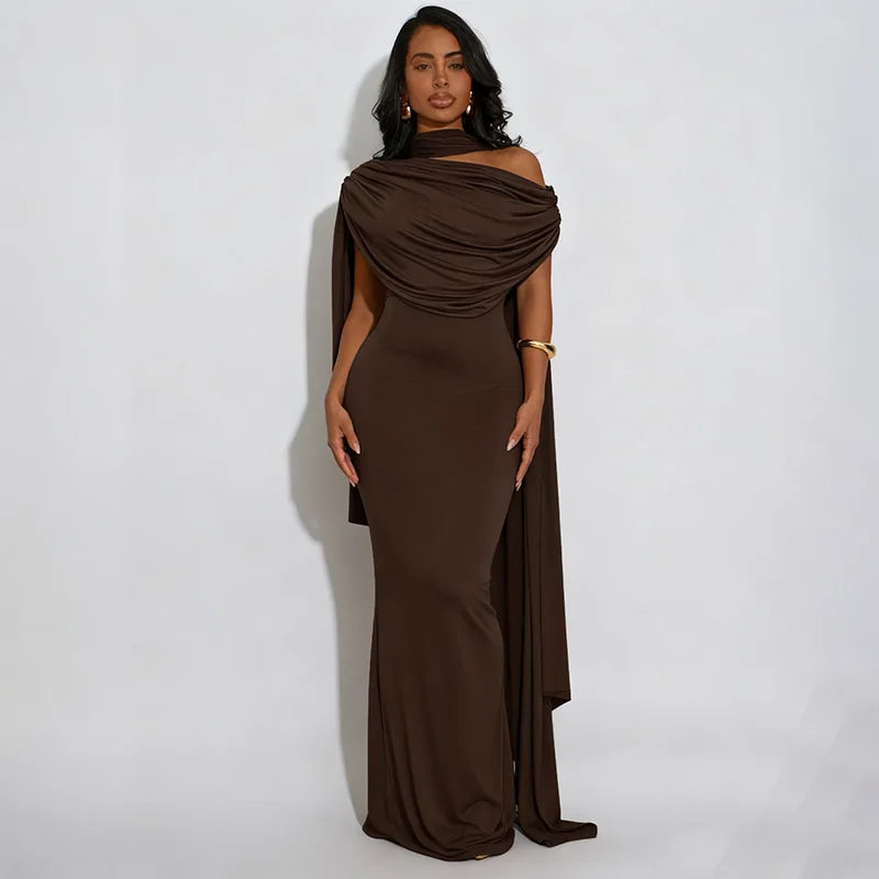 Woman wearing a brown evening gown against a white background
