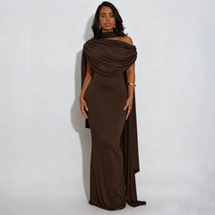 Woman wearing a brown evening gown against a white background