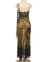 Black and gold patterned dress on a mannequin against a white background