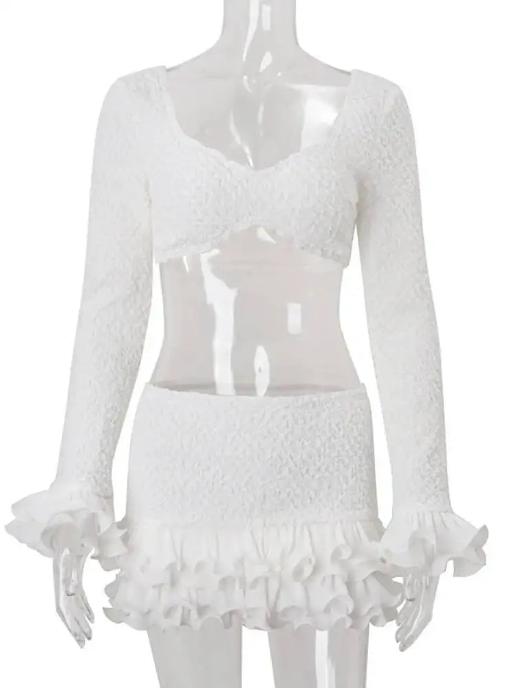 White lace top and skirt set on a mannequin against a white background