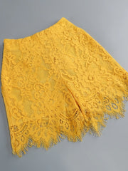 Yellow lace fabric on a gray background