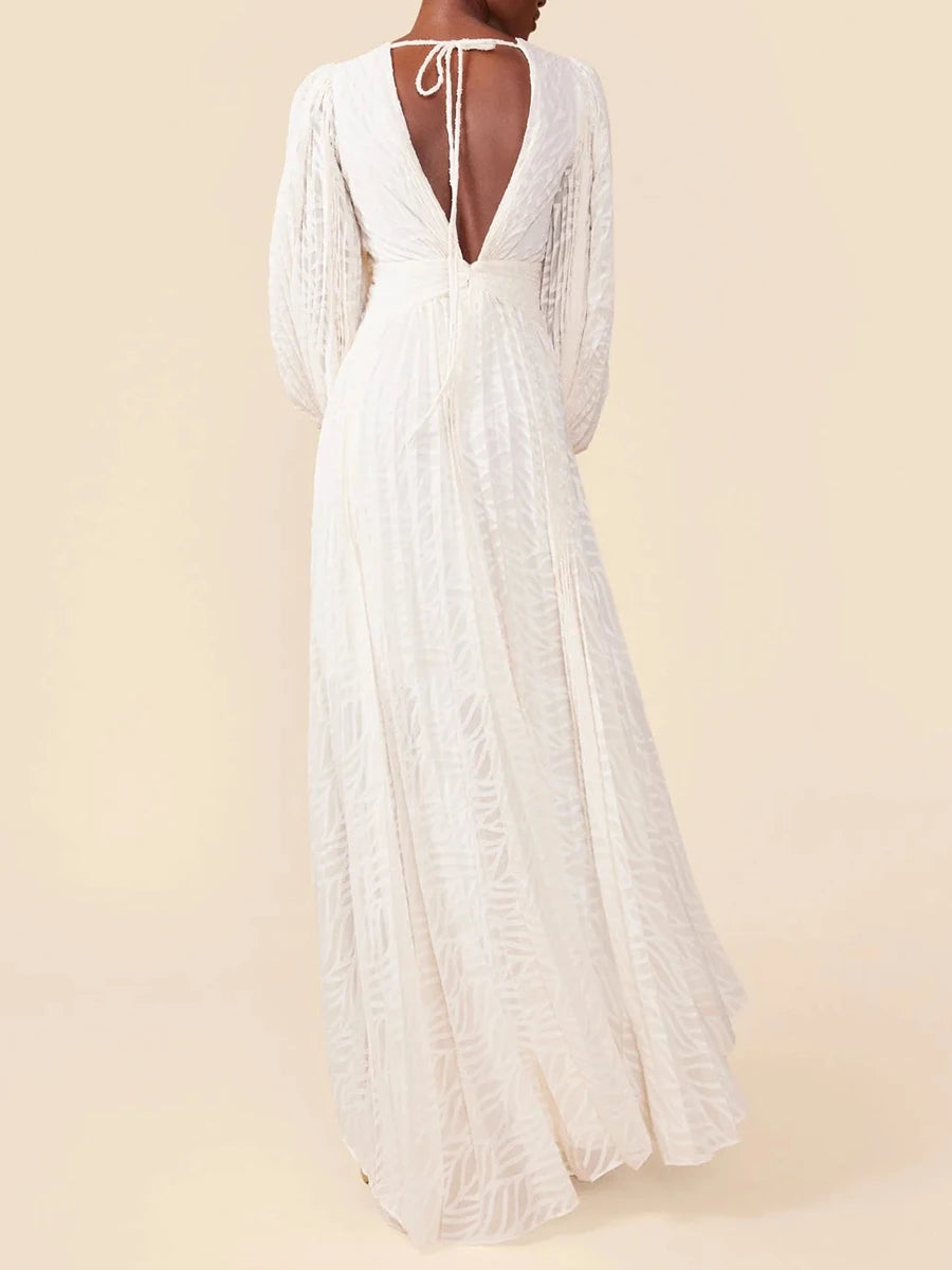 White lace dress with long sleeves on a beige background